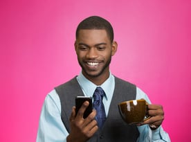 Happy, smiling business person reading this blog on a phone